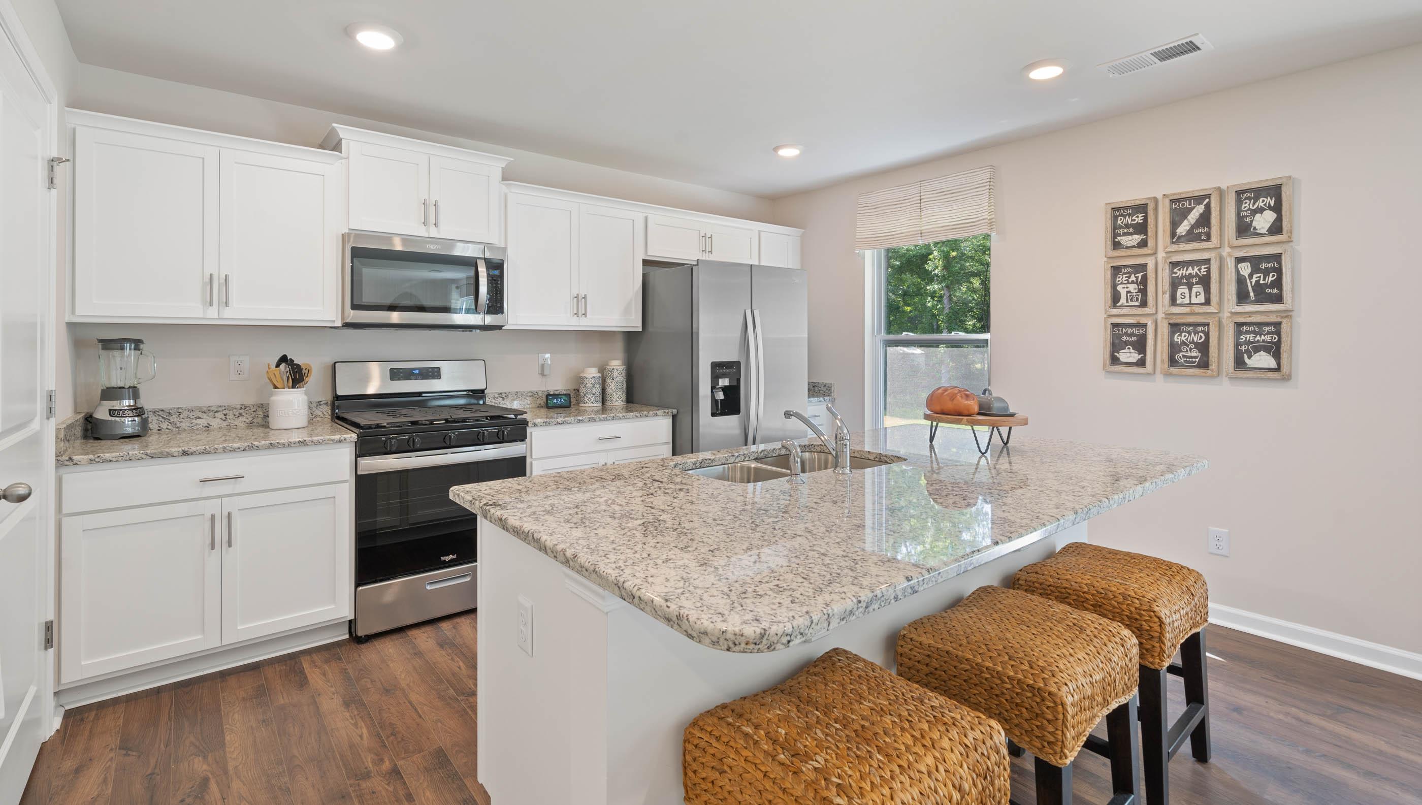 Kitchen and island with granite counter tops.