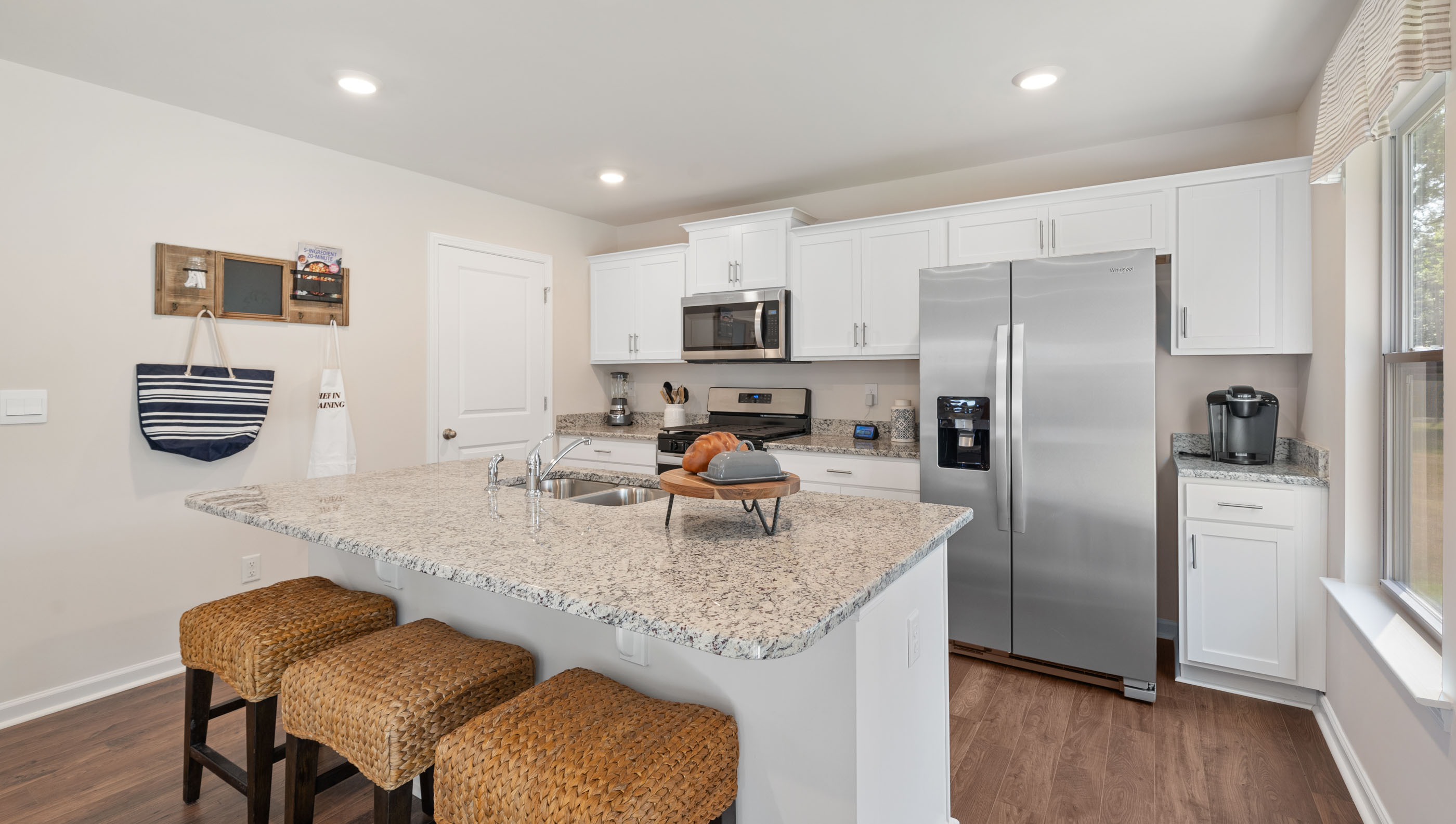 Kitchen and island with granite counter tops.
