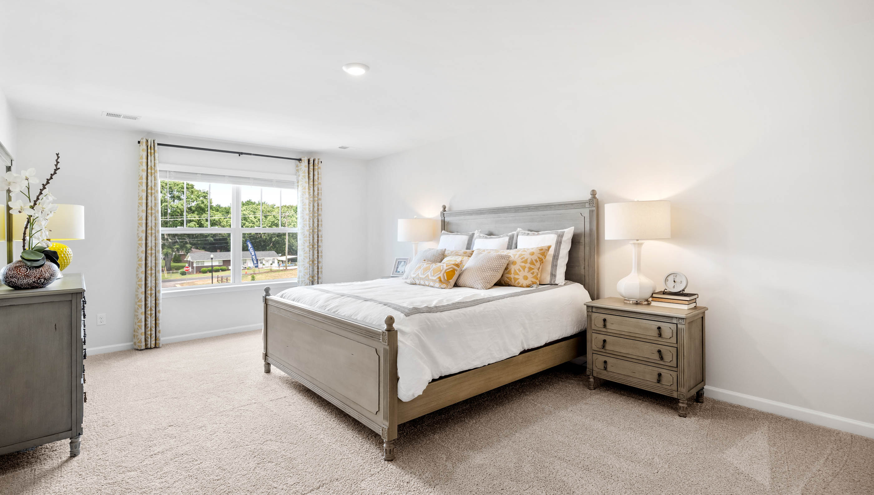 Bedroom with carpet and windows.