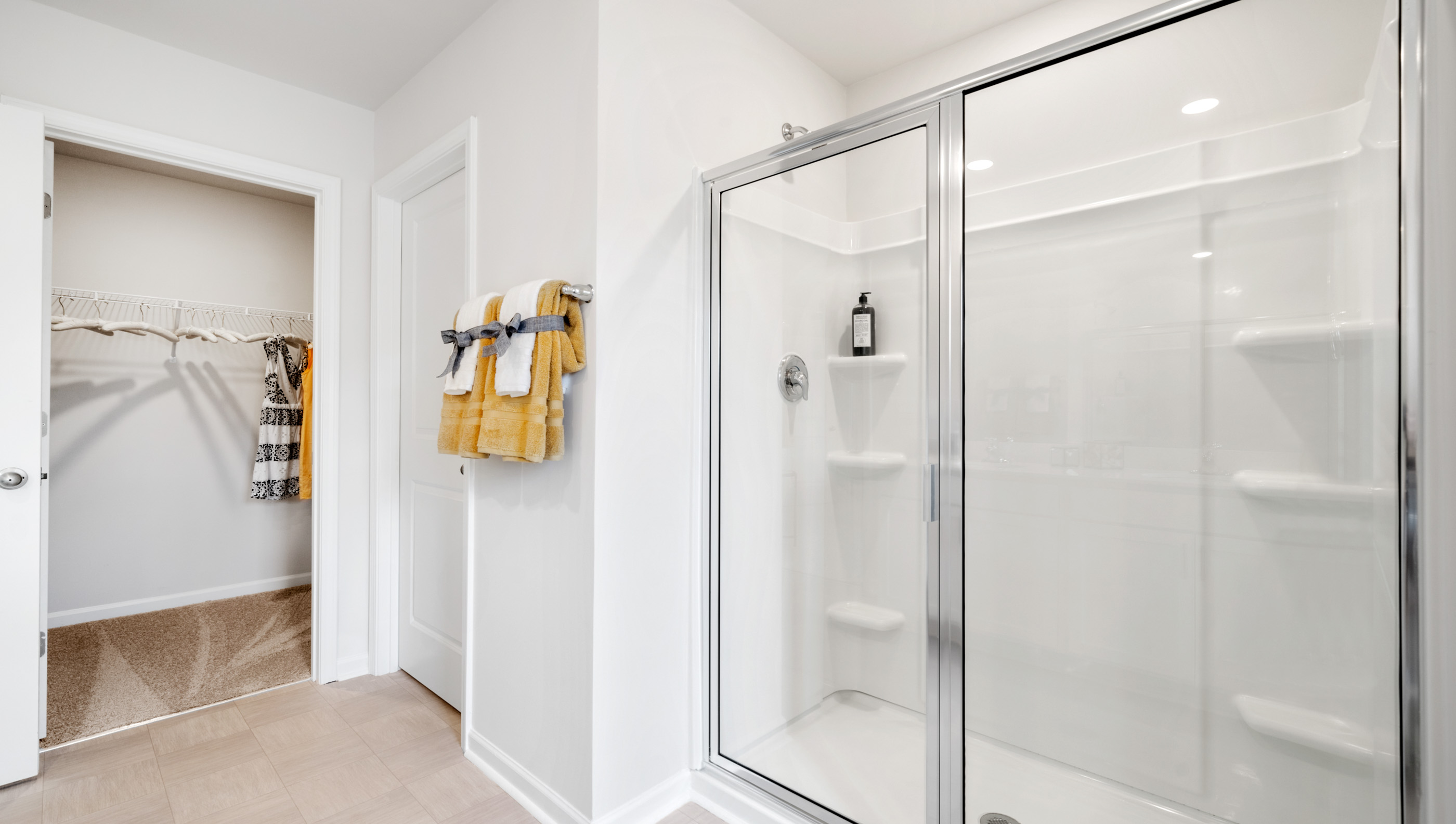 Bathroom with shower and linen closet.