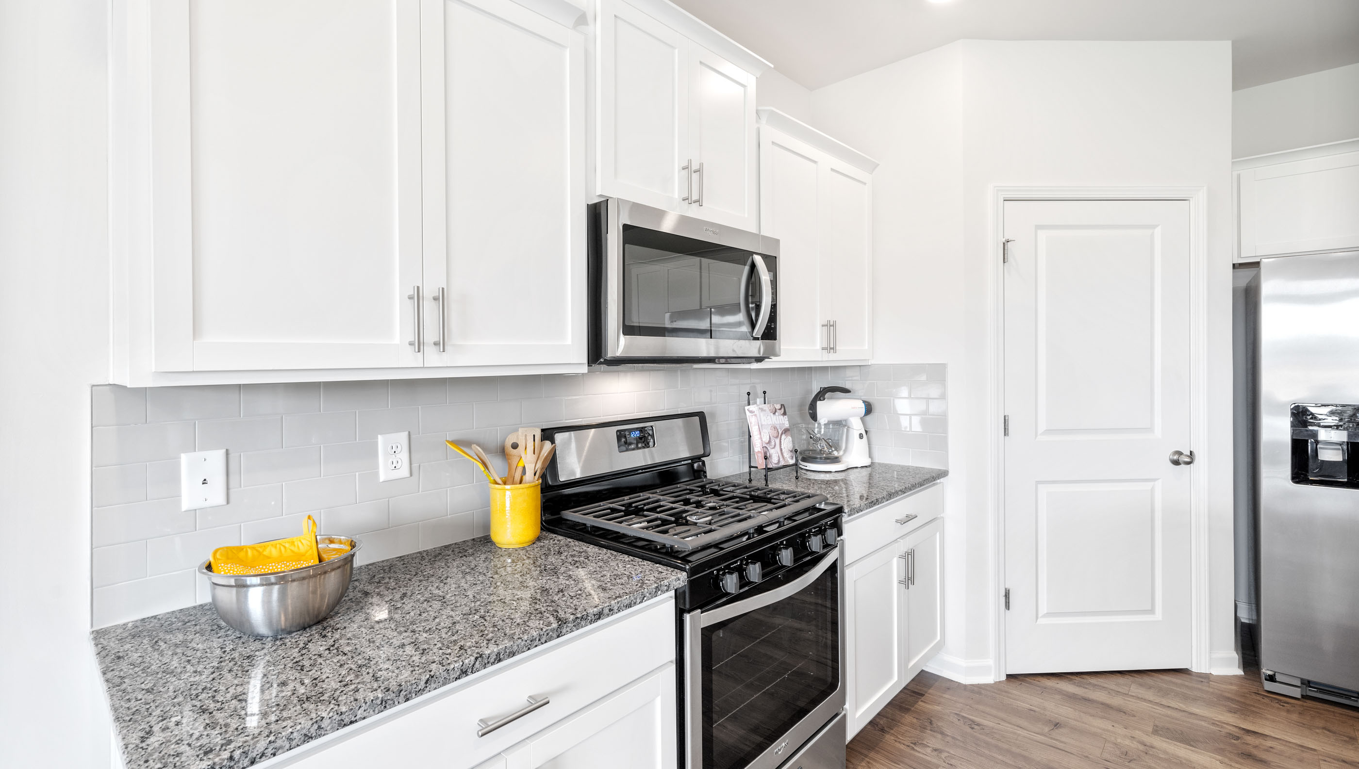 Kitchen and island with granite counter tops.