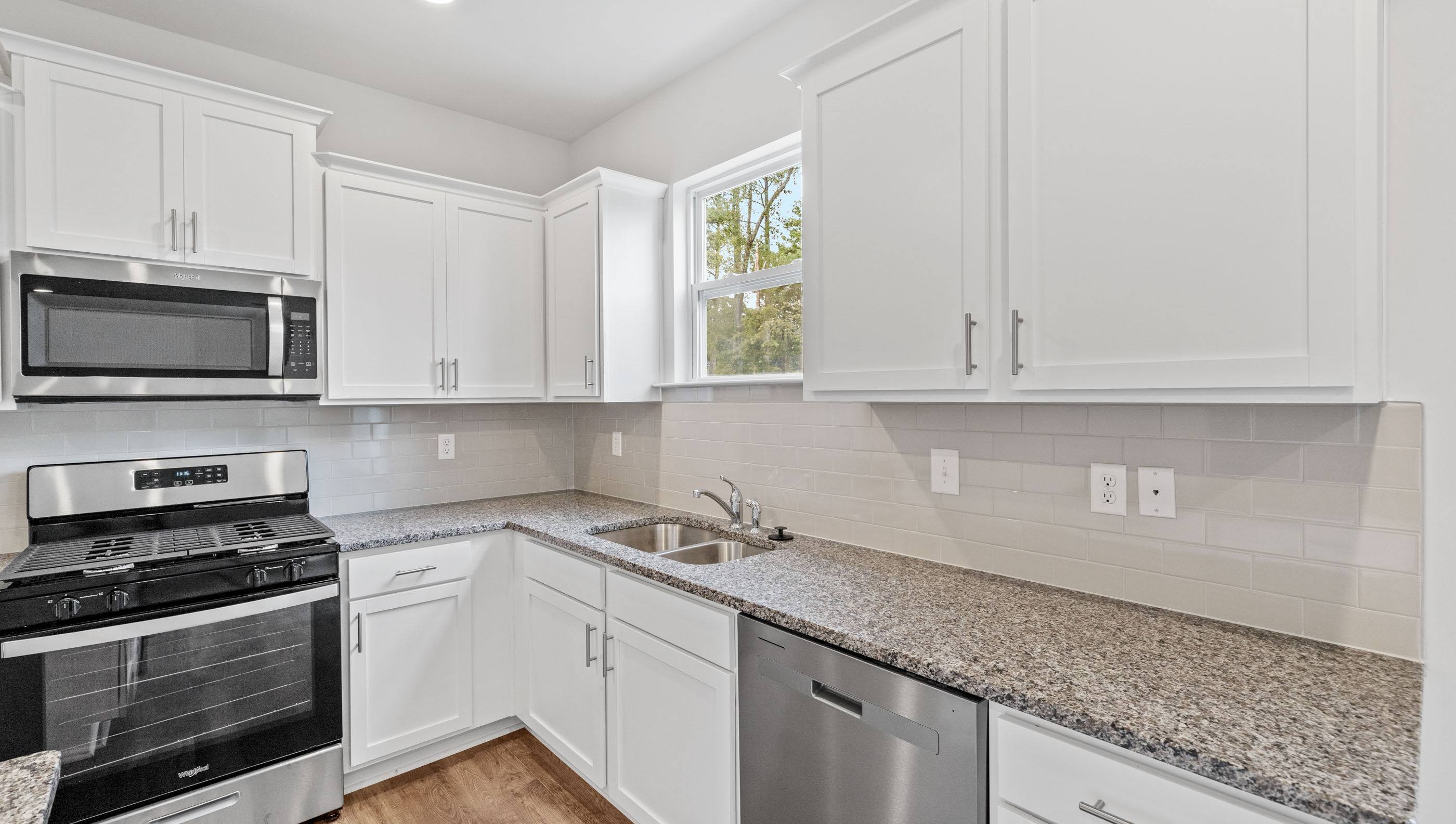 Kitchen and island with granite counter tops.