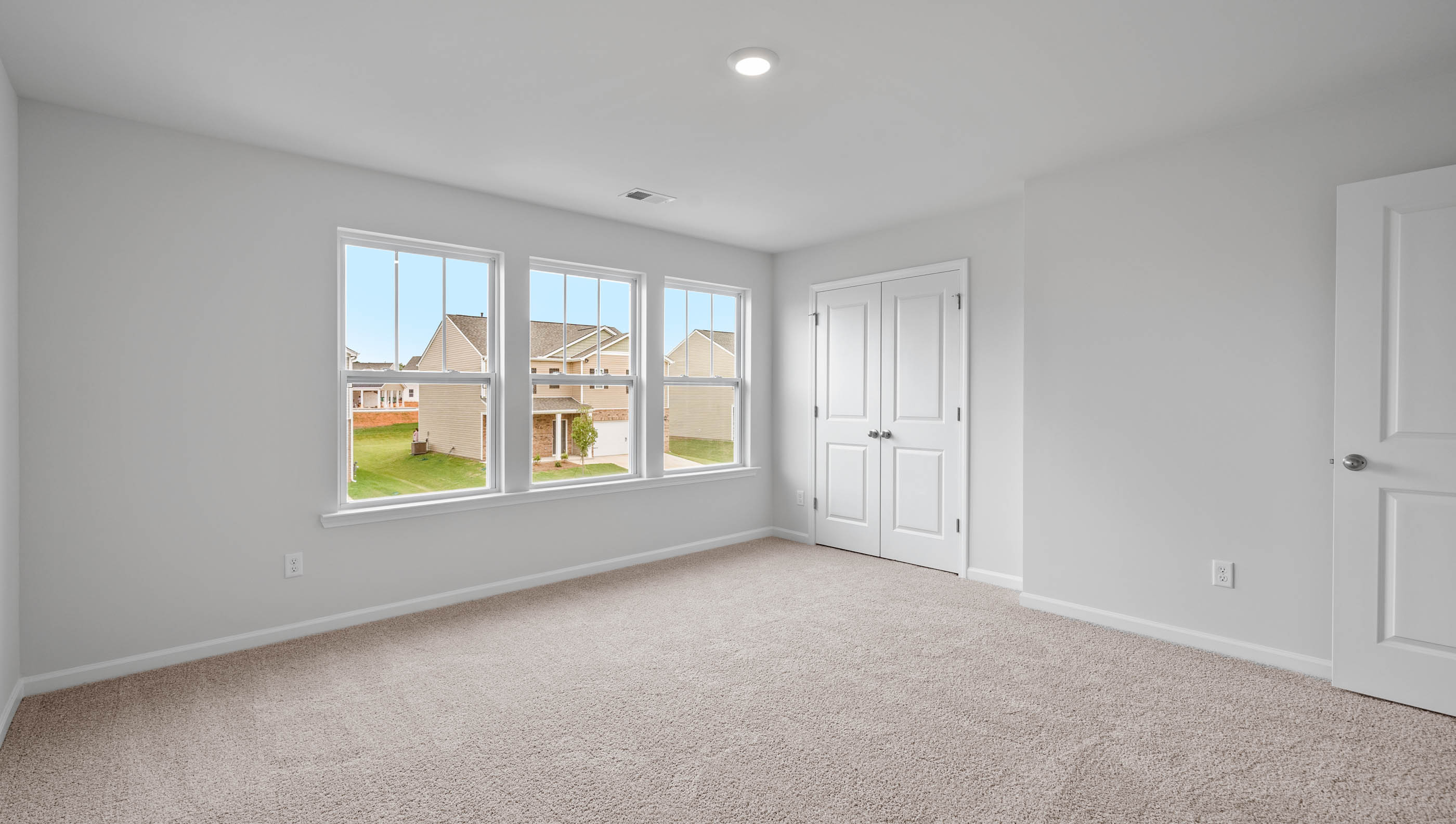 Bedroom with carpet and window.