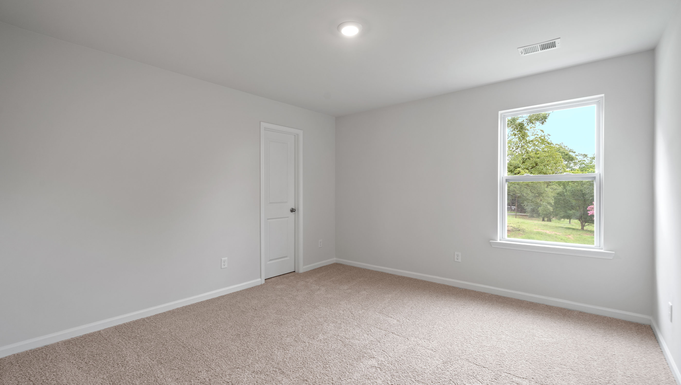 Bedroom with carpet and window.