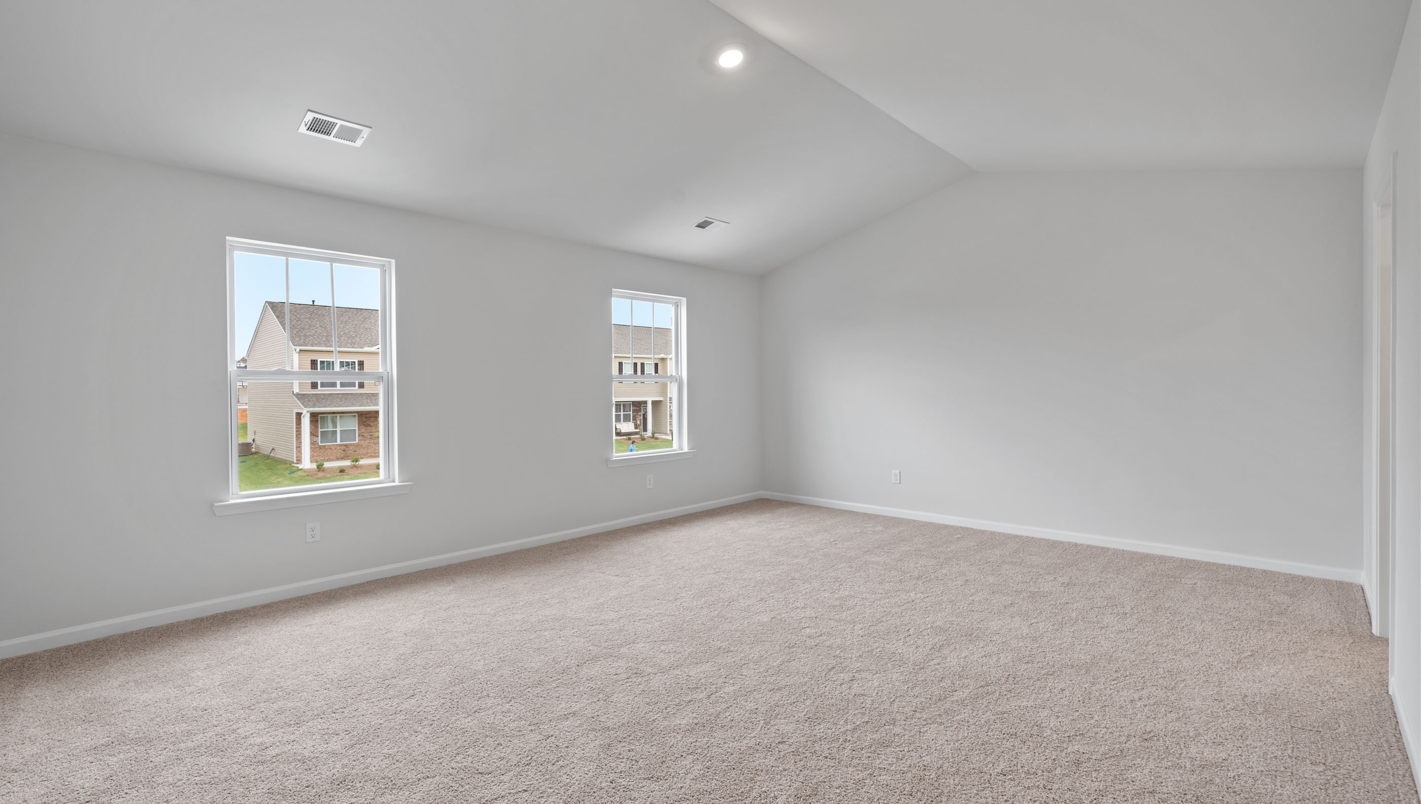 Bedroom with carpet and window.