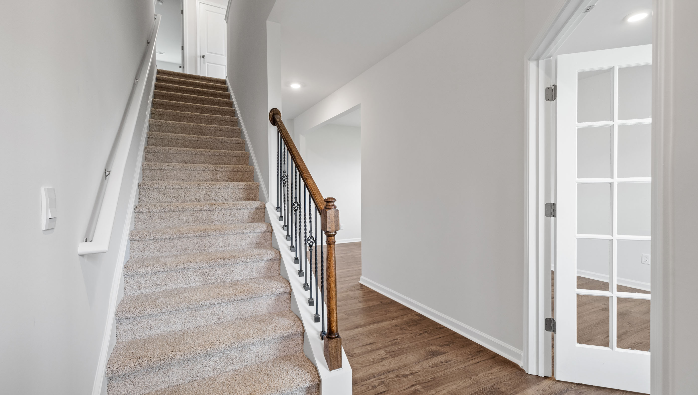 Hallway into home with stairs.