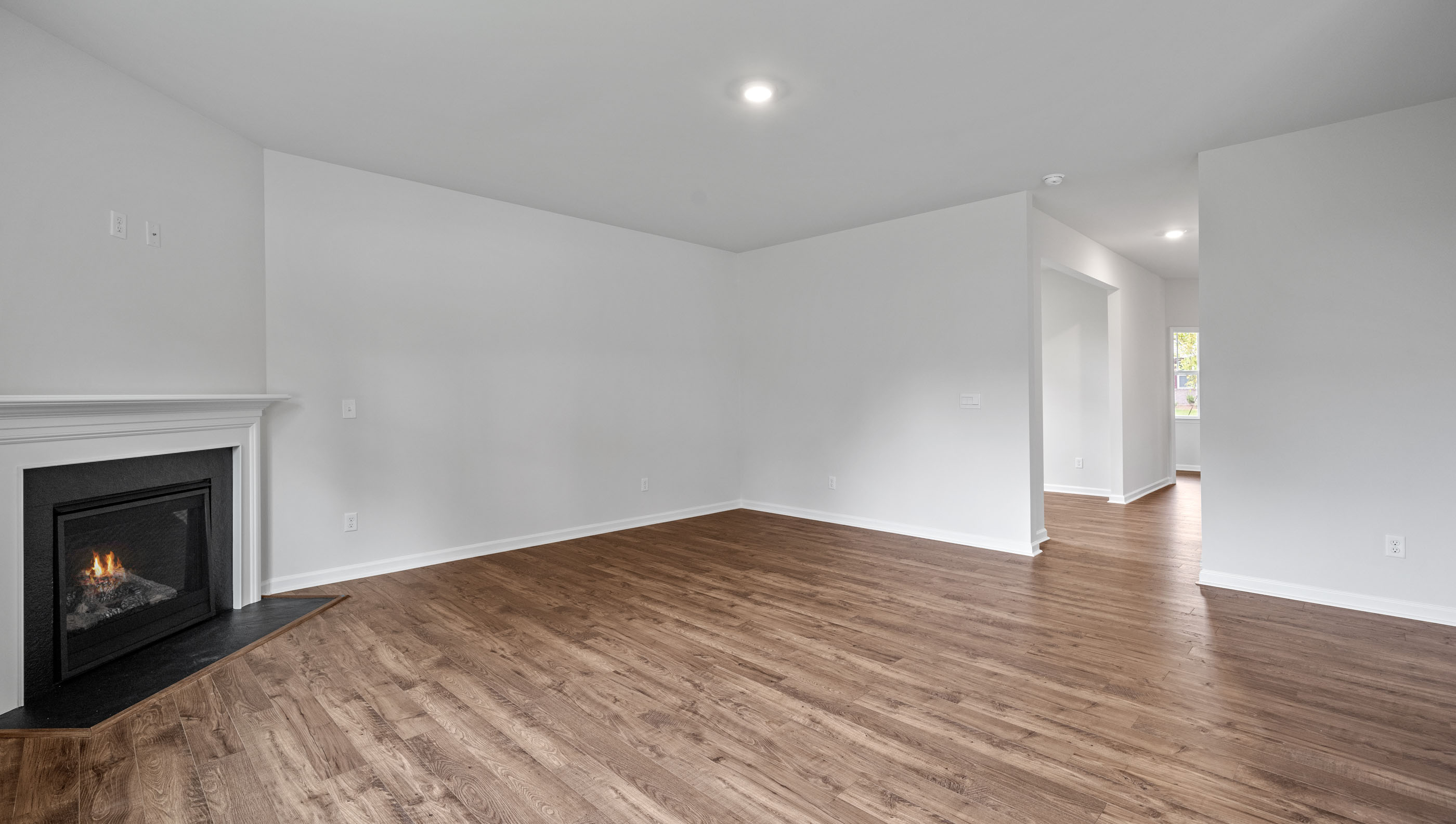 Family room with fireplace and windows.