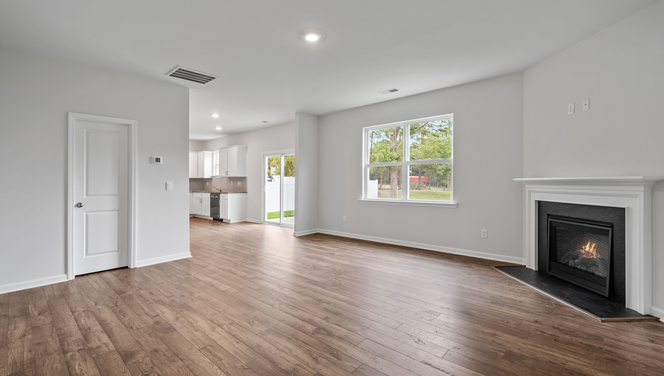 Family room with fireplace and windows.