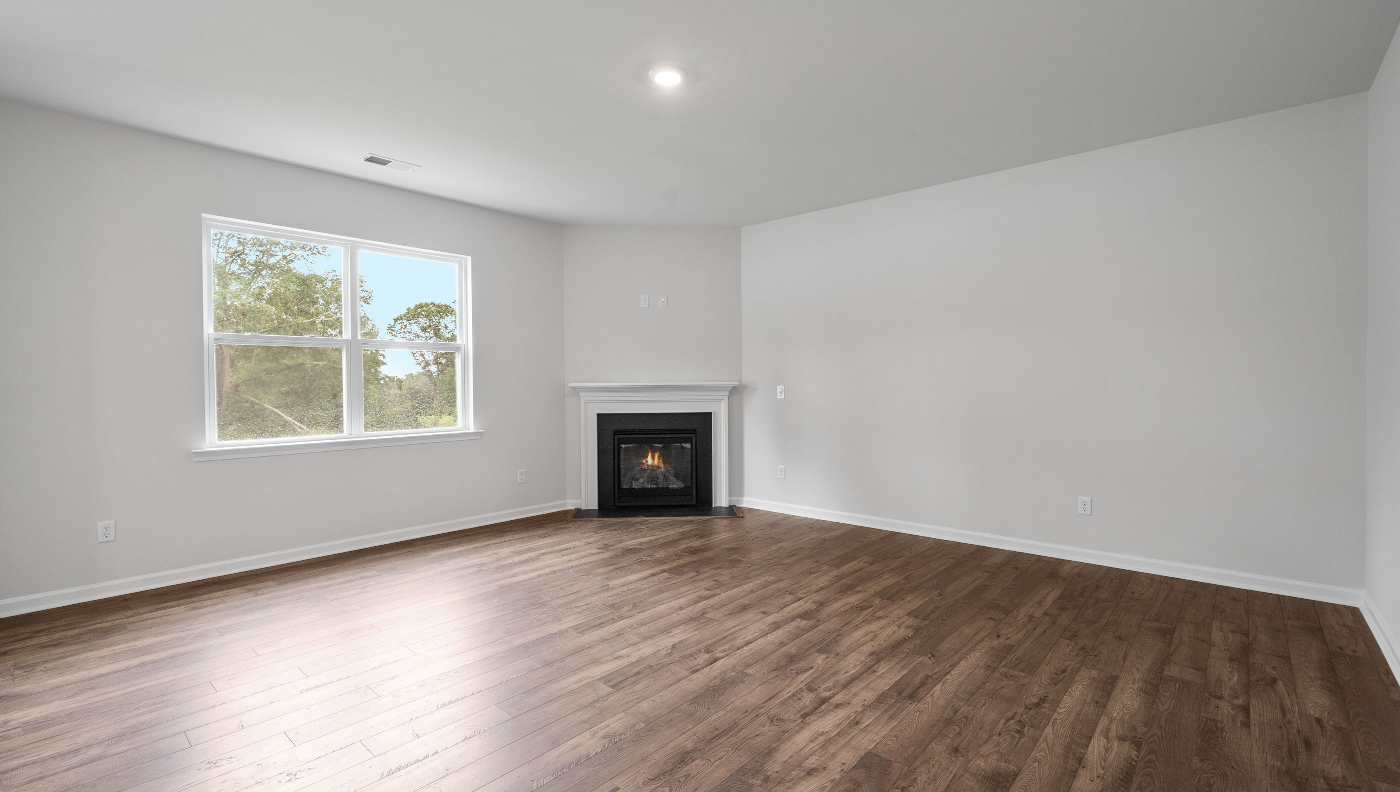 Family room with fireplace and windows.