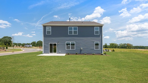 Back exterior with large backyard.