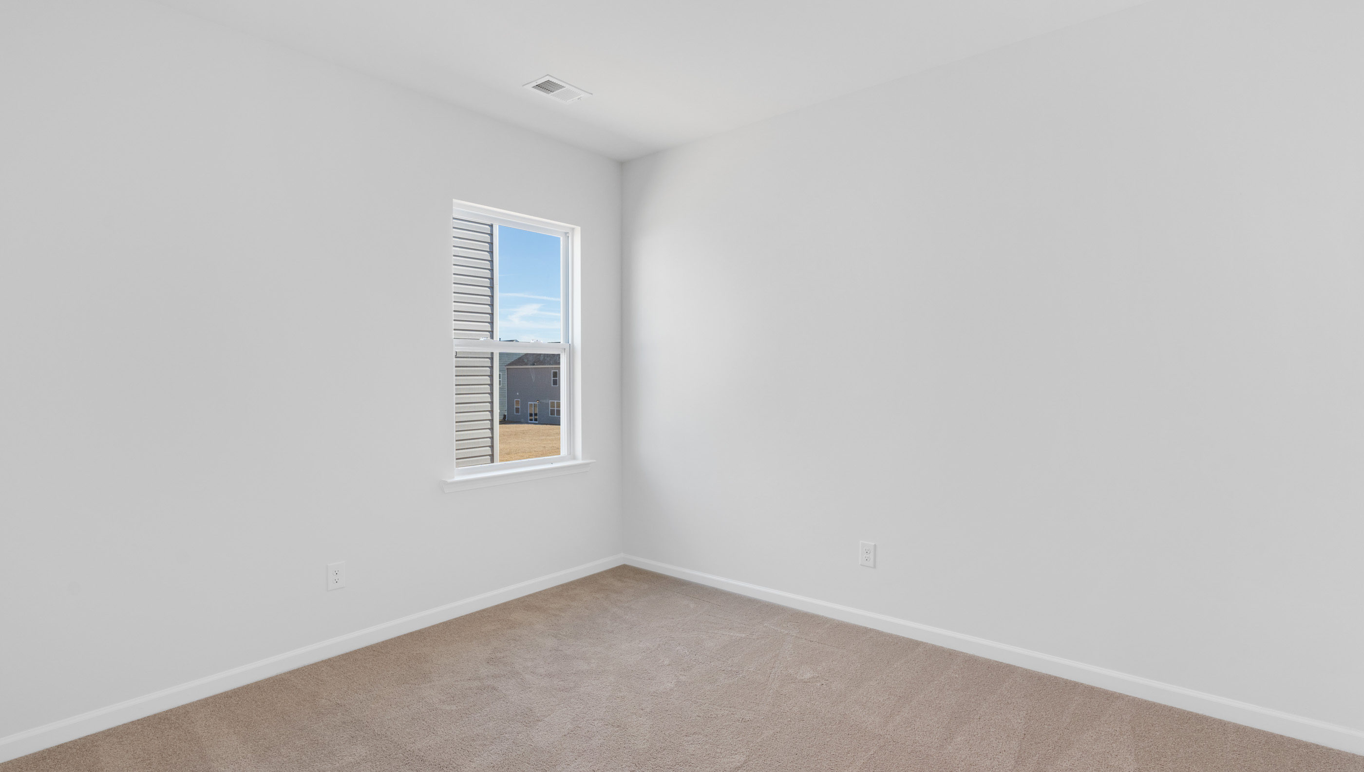 Bedroom with carpet and window.