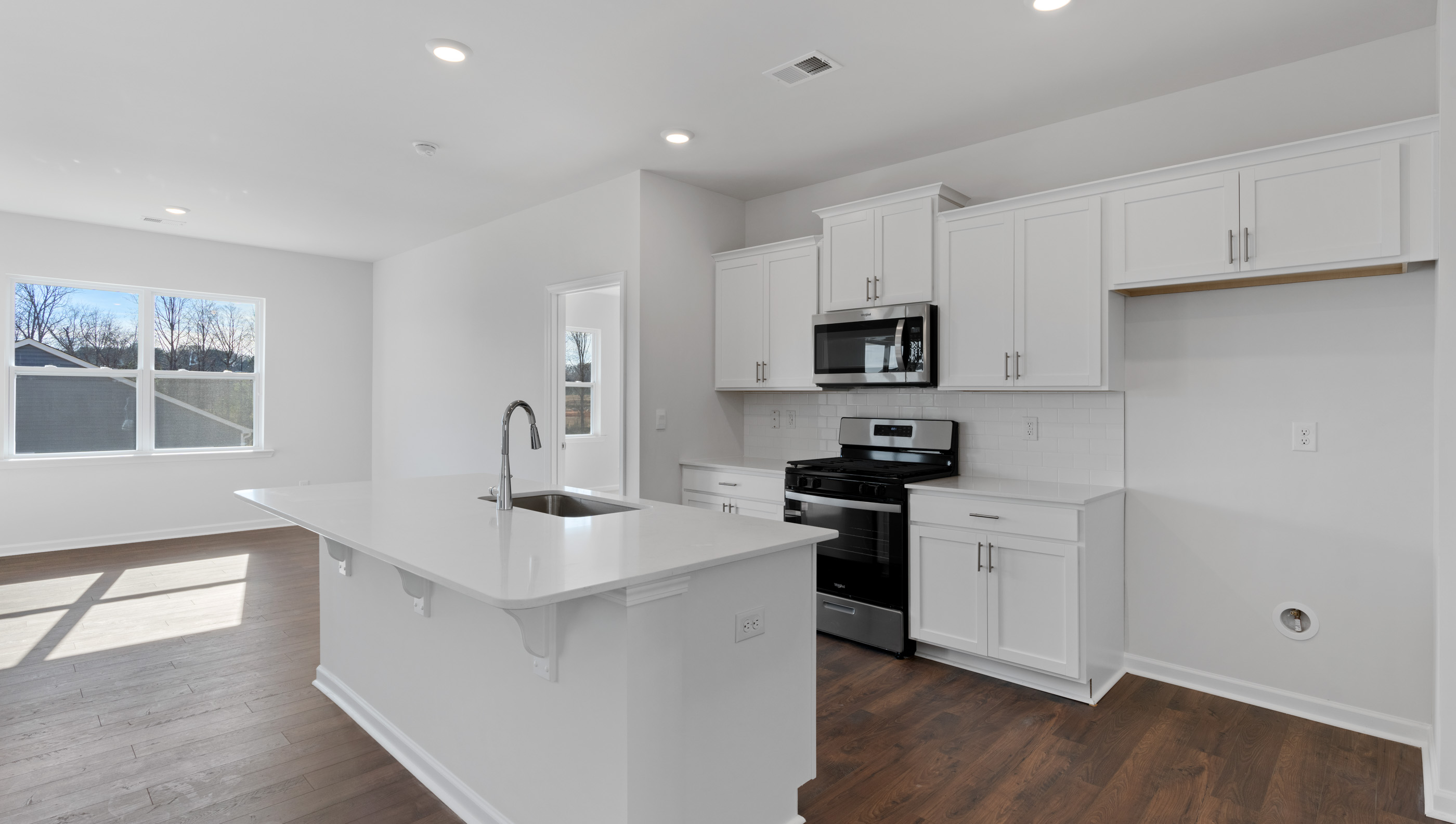 Kitchen and island with granite counter tops.