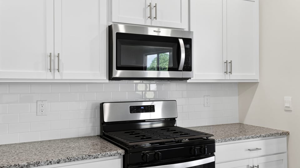 Kitchen with island and cabinets.