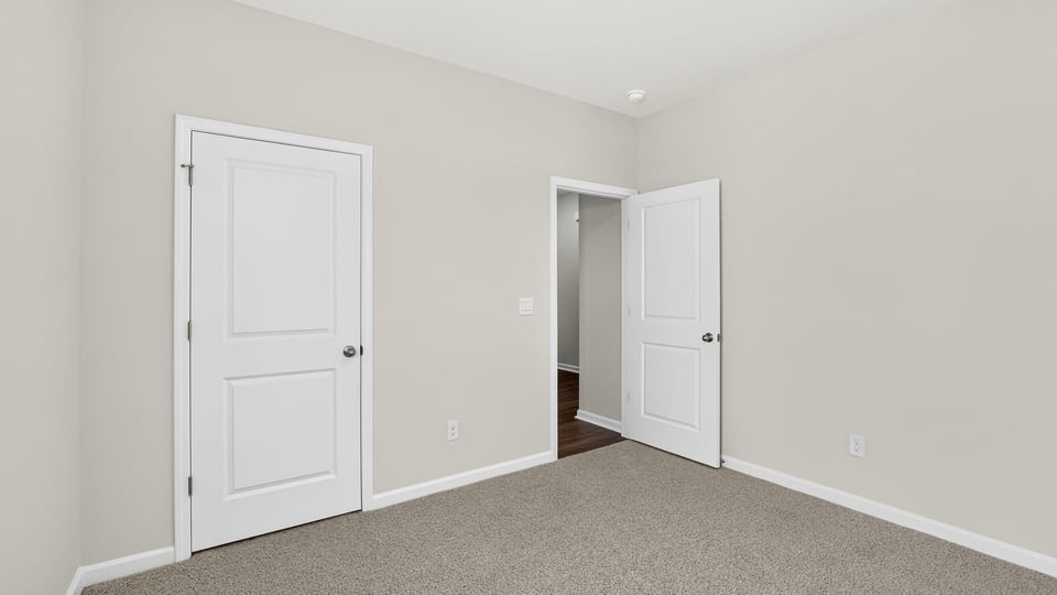 Bedroom with carpet and windows,