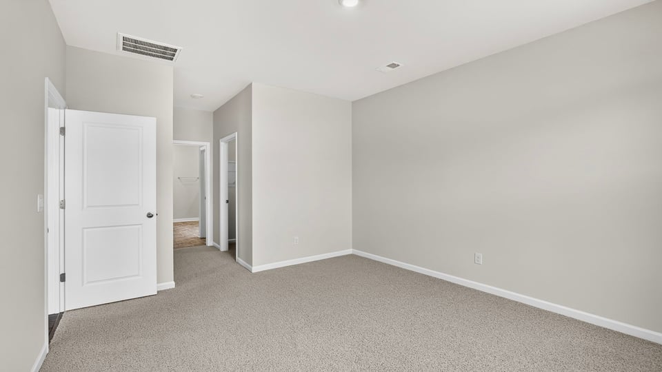 Bedroom with carpet and windows,