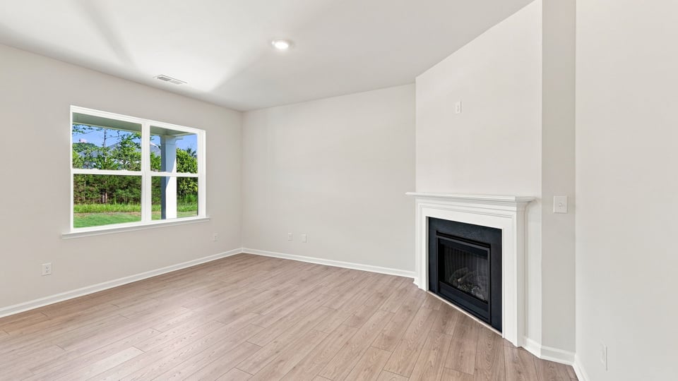 Living room with fireplace and windows.