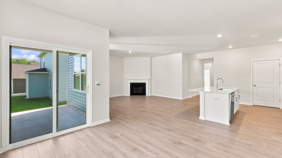 Living room with fireplace and windows.