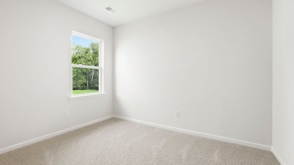 Bedroom with carpet and windows.