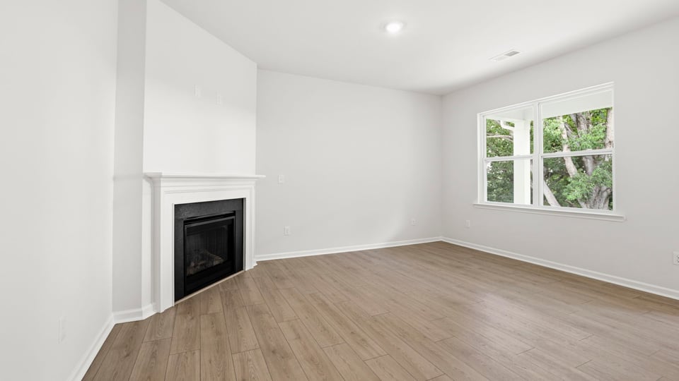 Living area with fireplace and windows.