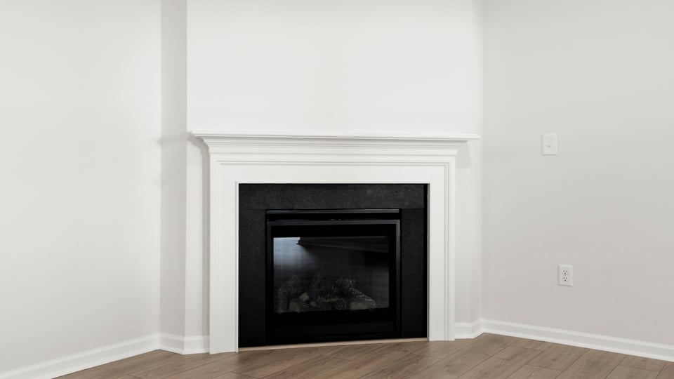 Living area with fireplace and windows.