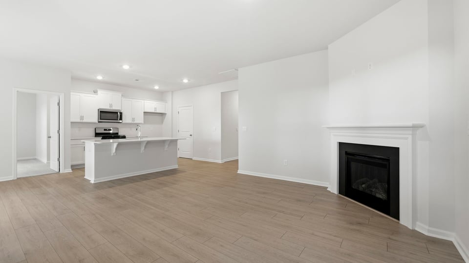 Living area with fireplace and windows.