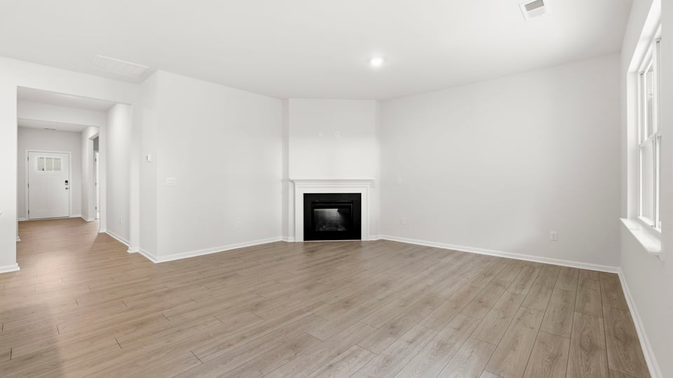 Living area with fireplace and windows.