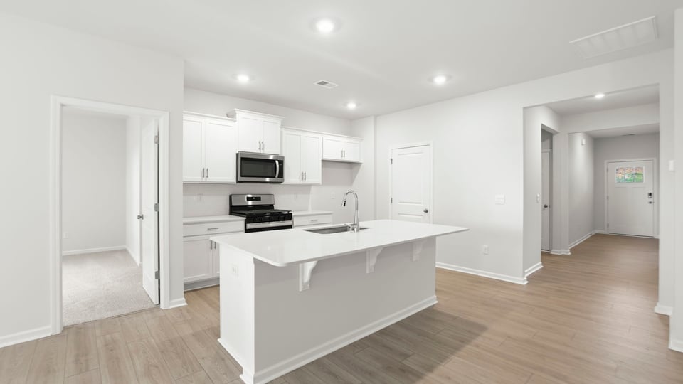 Kitchen with island and cabinets.