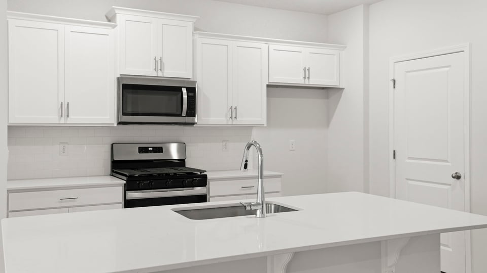 Kitchen with island and cabinets.