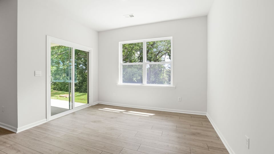 Living area with fireplace and windows.