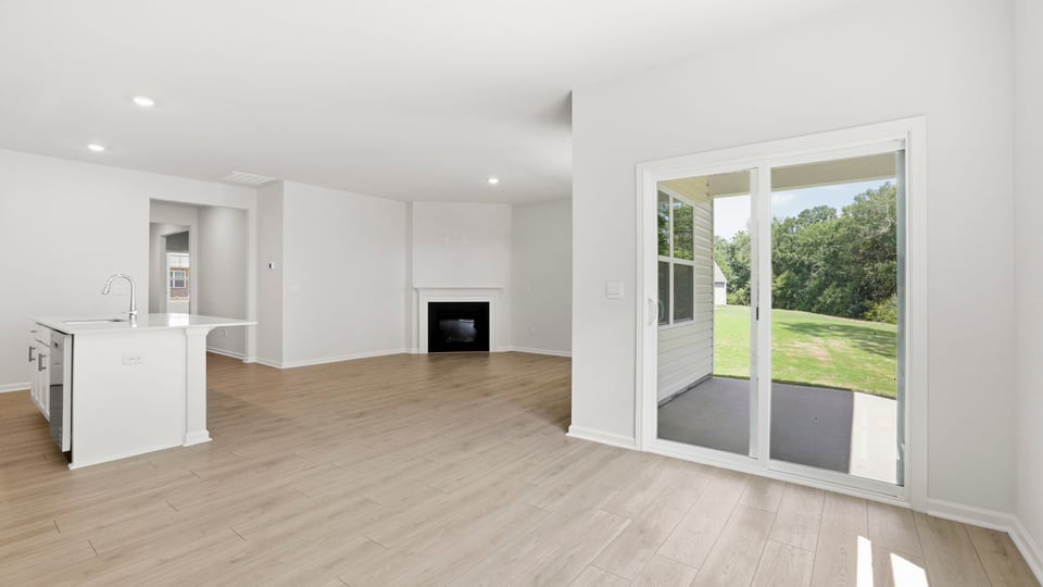 Living area with fireplace and windows.