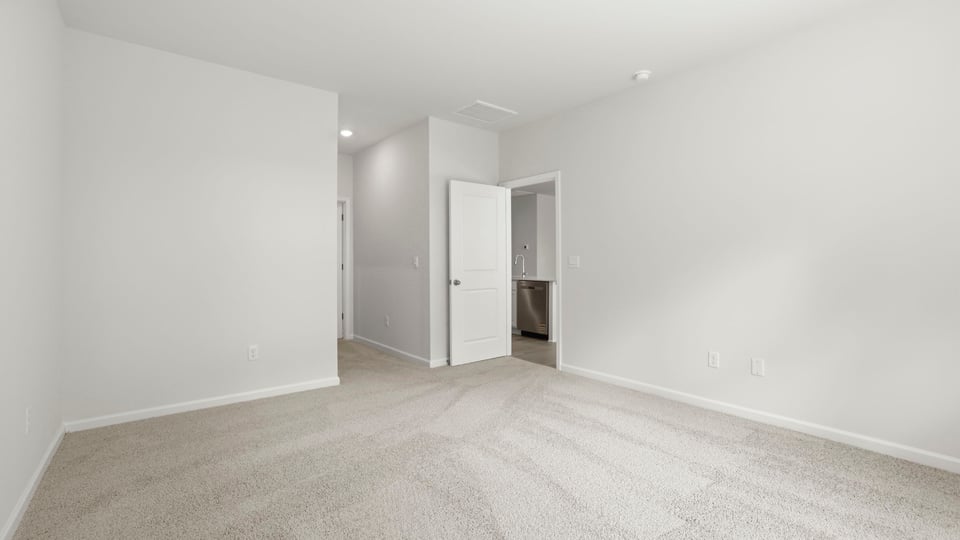 Bedroom with carpet and windows.