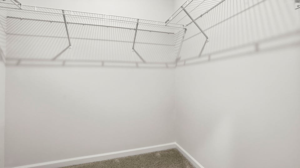 Primary closet with shelf.