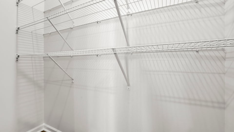 Primary closet with shelf.