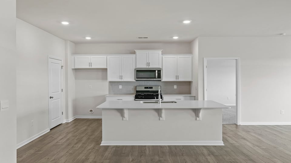 Kitchen with island and cabinets.