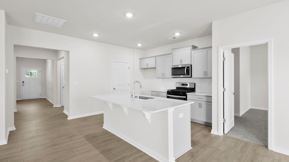 Kitchen with island and cabinets.