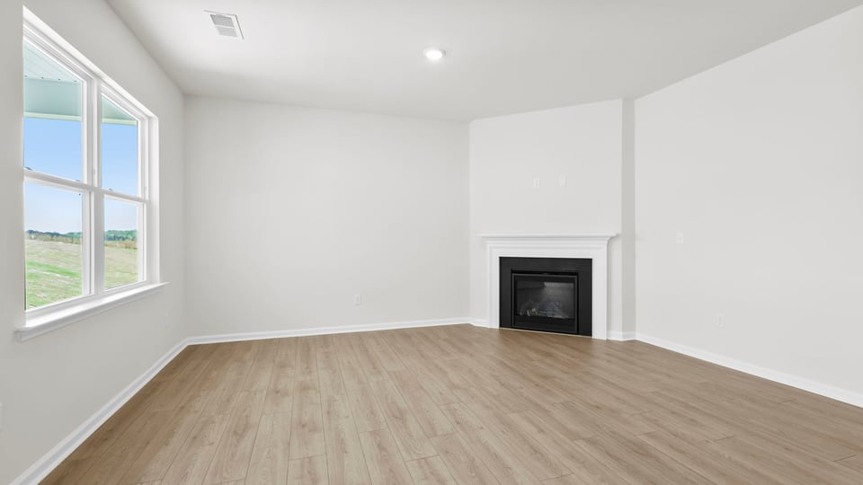 Living area with fireplace and windows.