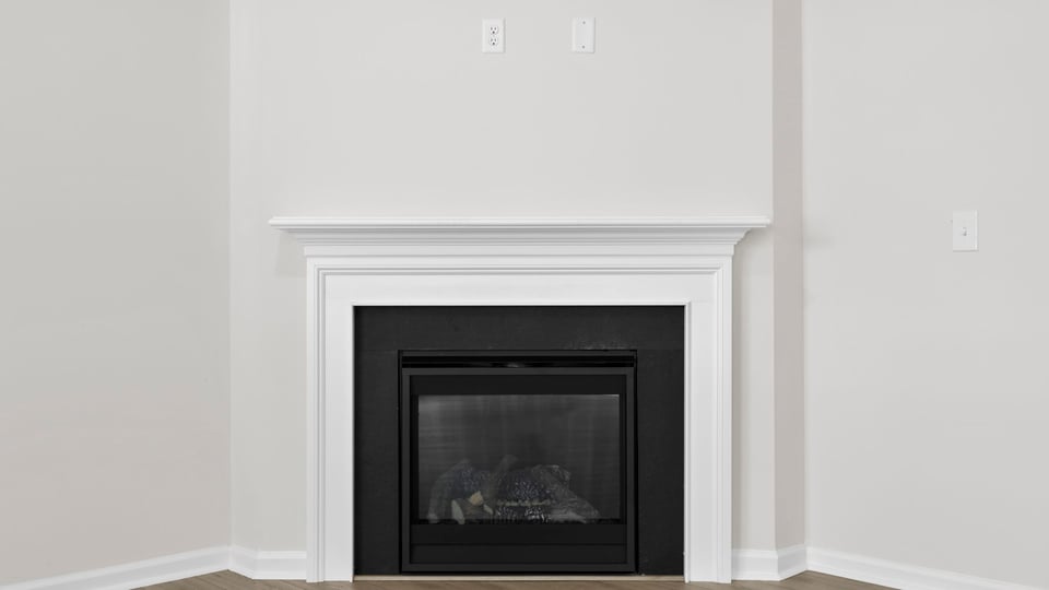 Living area with fireplace and windows.