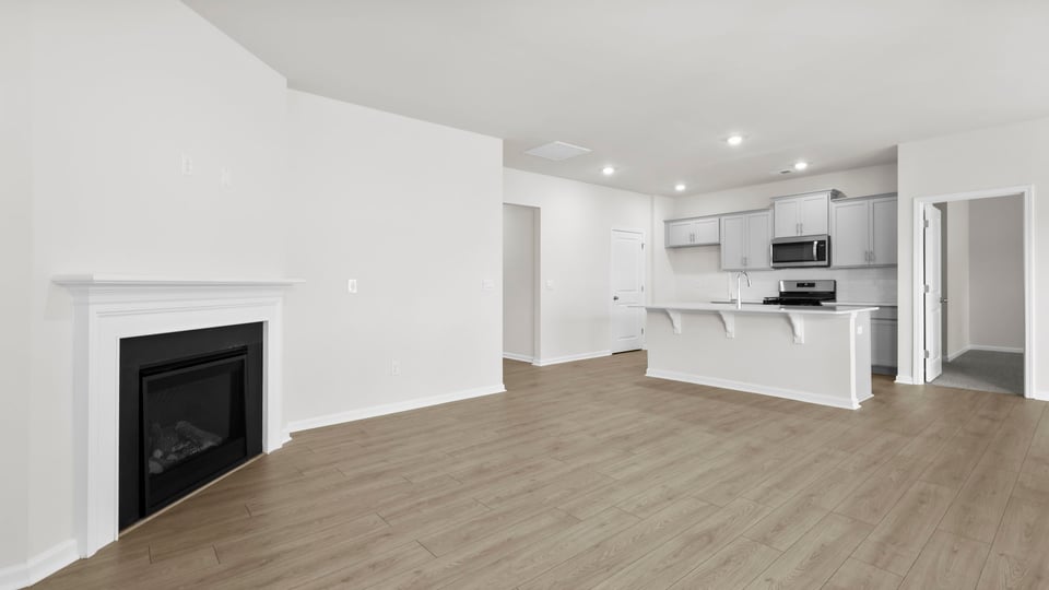 Living area with fireplace and windows.