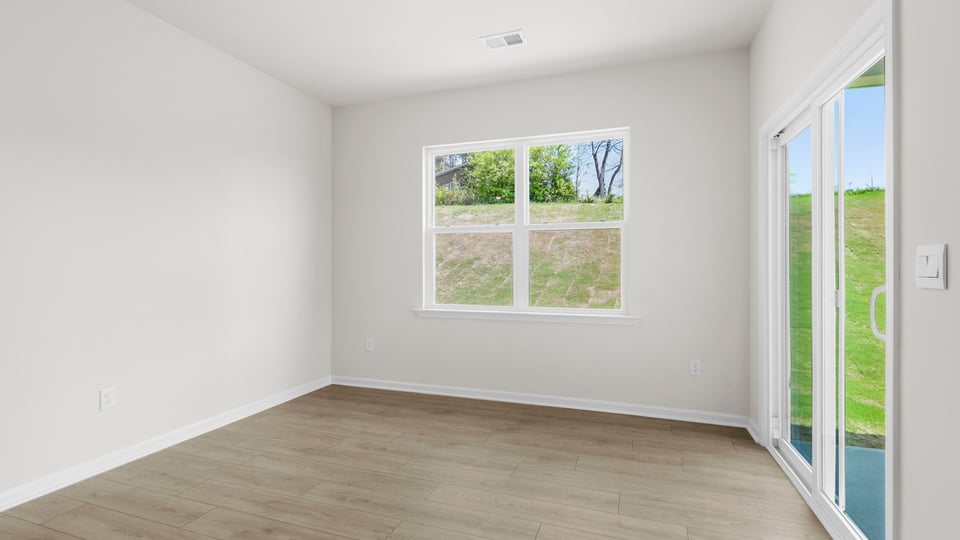 Living area with fireplace and windows.