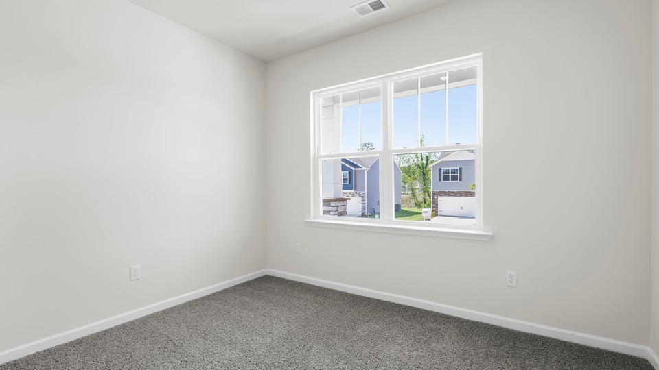 Bedroom with carpet and window.