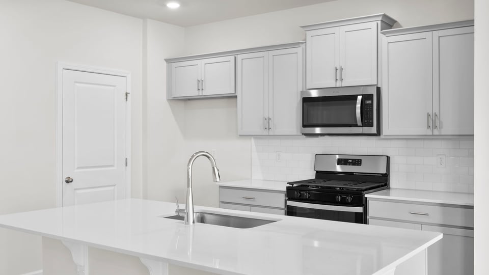 Kitchen with island and cabinets.