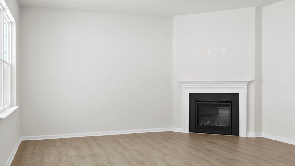 Living room with fireplace and windows.