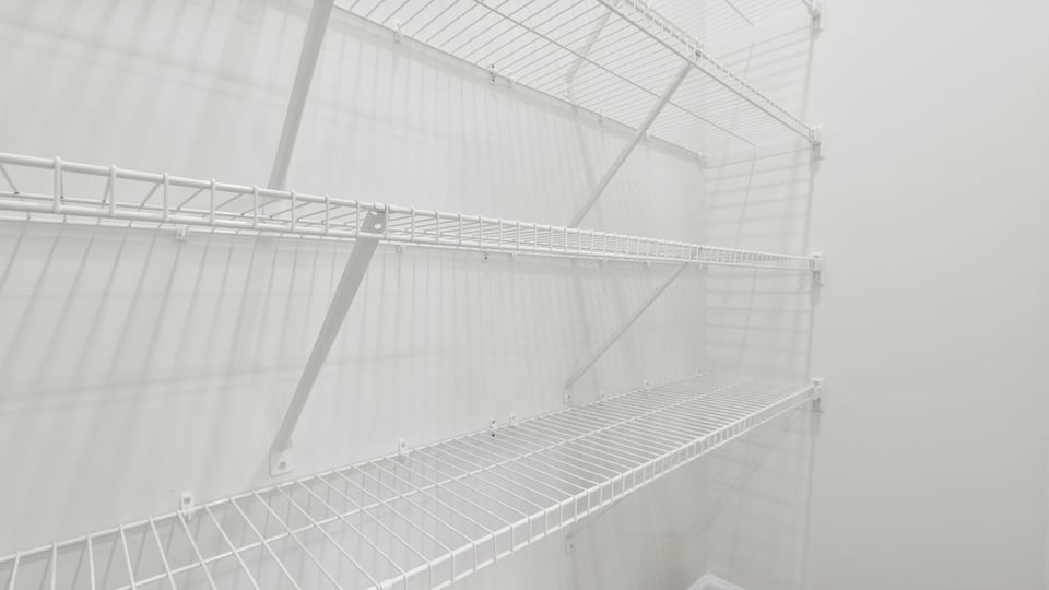 Primary closet with shelf.