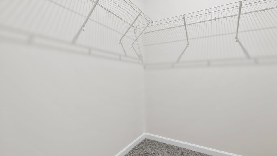 Primary closet with shelf.