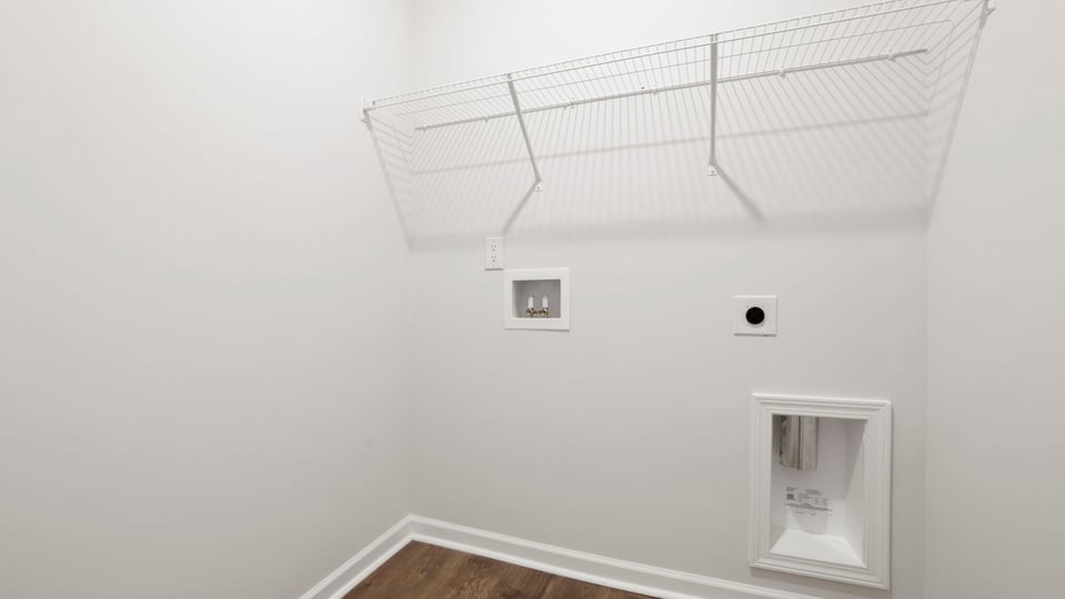 Laundry room with hanging storage racks.