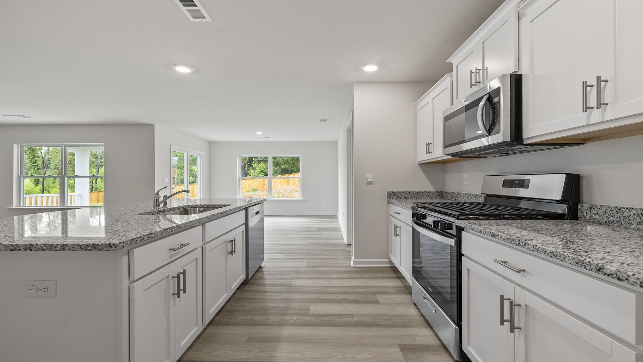 Kitchen and island have quartz countertops.
