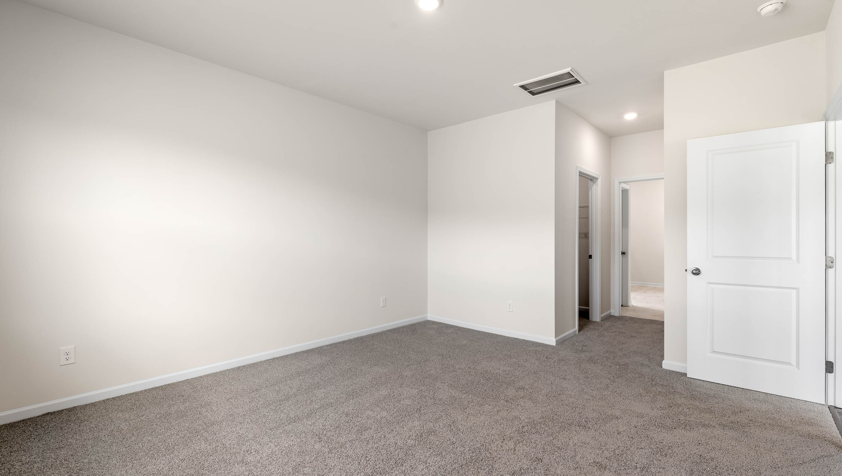 Bedroom with carpet and window.