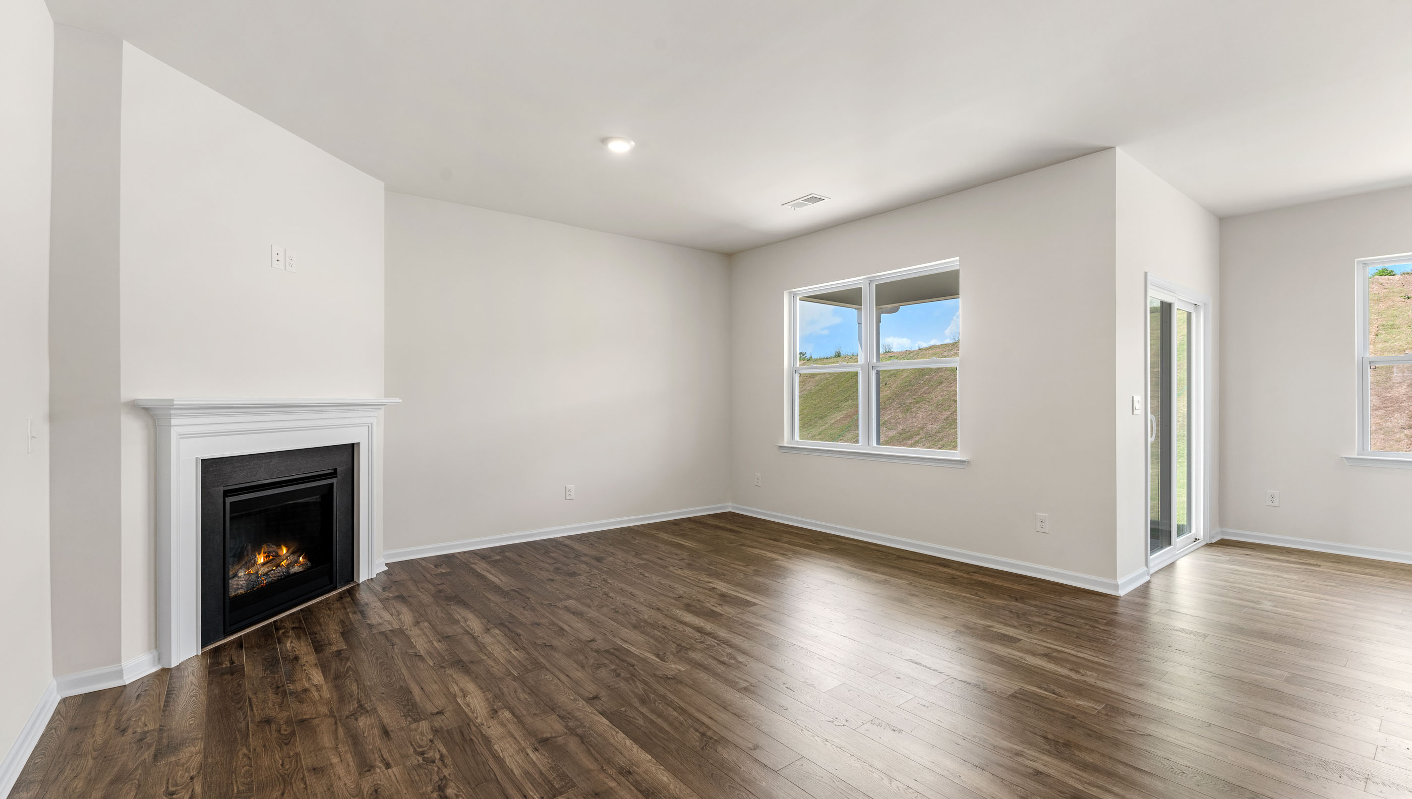 Livingroom with fireplace and window.