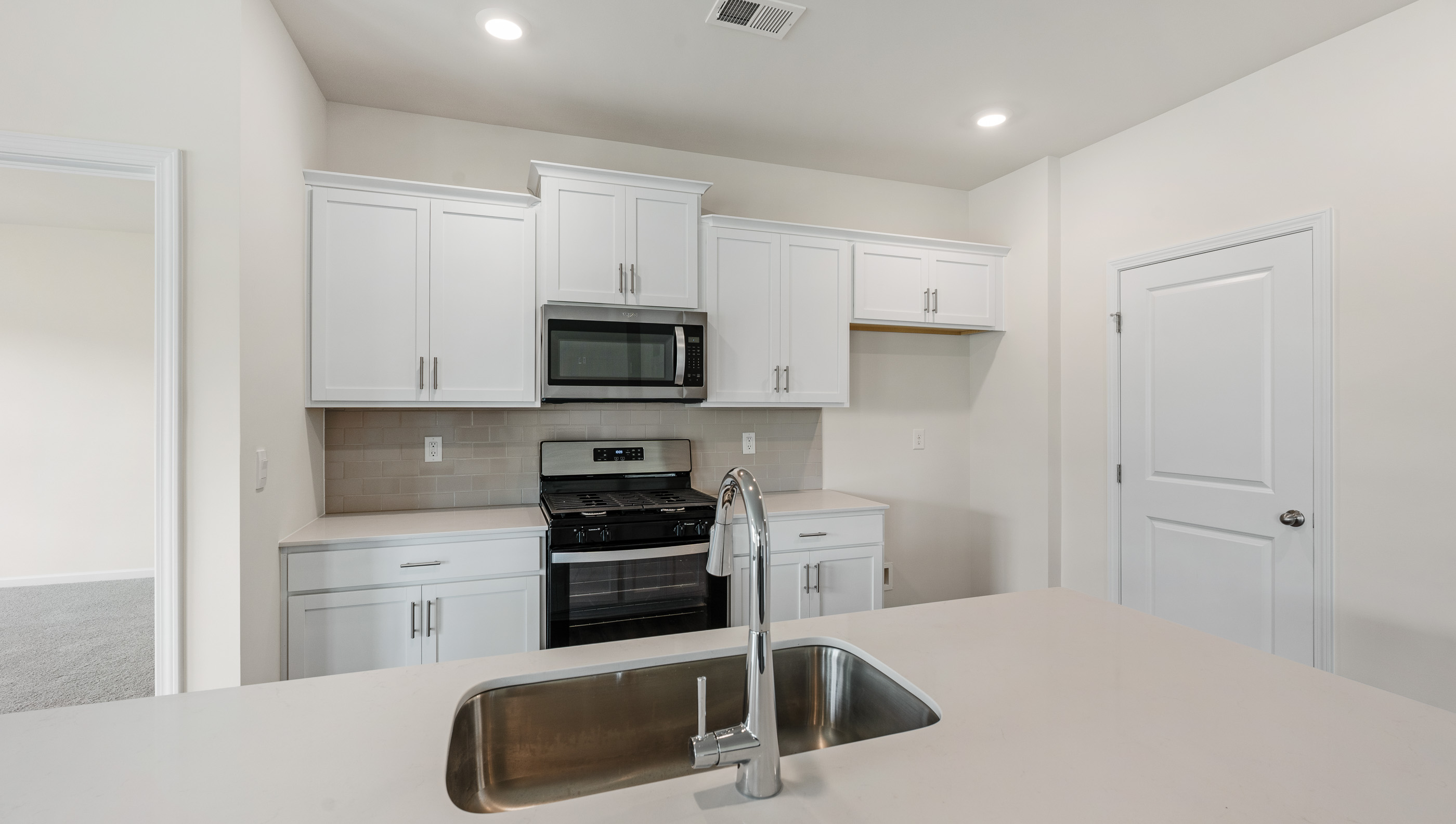 Kitchen with quartz countertop.