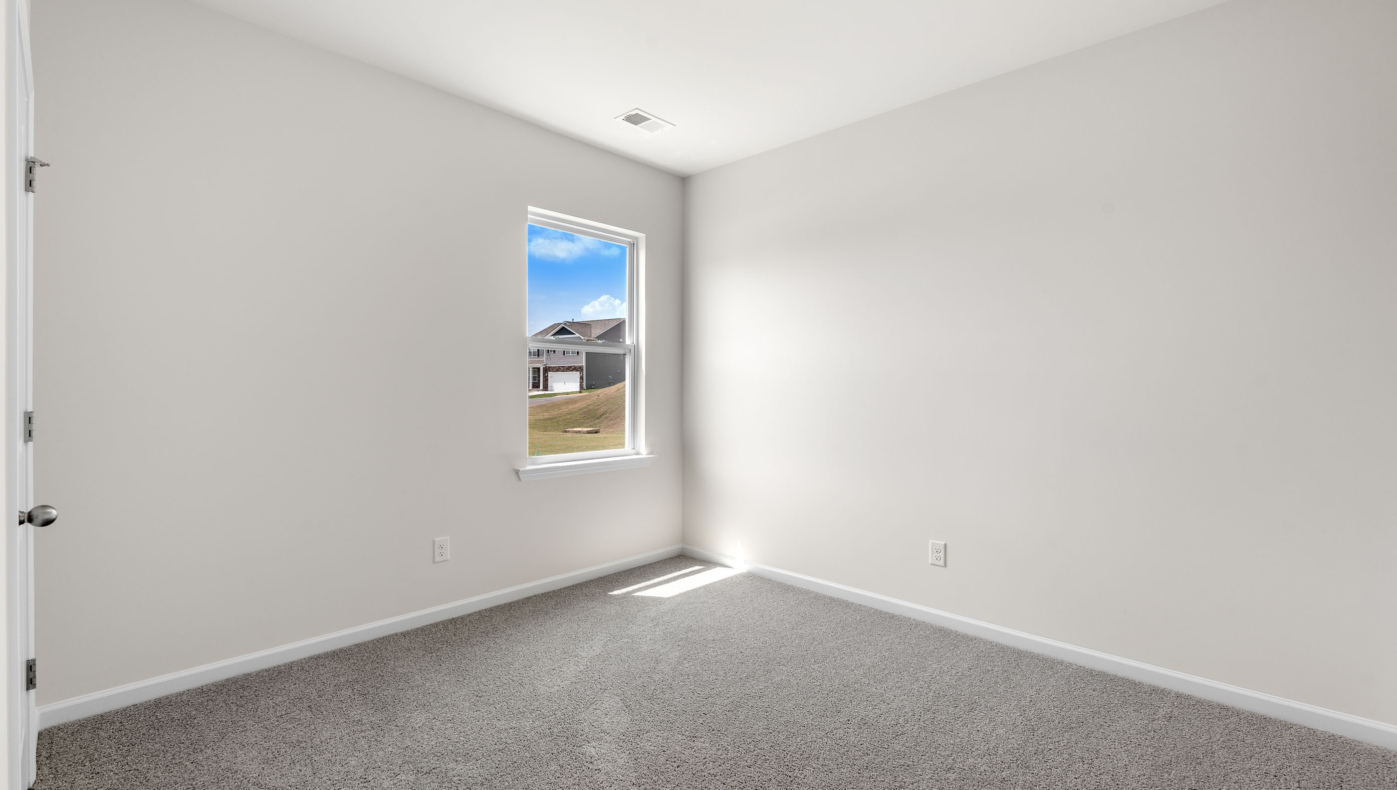 Bedroom with carpet and window.